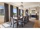 Well-lit dining room featuring a dark wood table and view of the outside at 5192 Sedona Dr, Parker, CO 80134