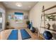Brightly lit exercise room with wood floors, window, workout mats, and shelving at 5192 Sedona Dr, Parker, CO 80134