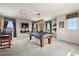 Spacious game room featuring a pool table, TV, and bar seating area with lots of natural light at 5192 Sedona Dr, Parker, CO 80134