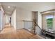 Upstairs hallway with wood floors, iron railings, and a window with a scenic view at 5192 Sedona Dr, Parker, CO 80134
