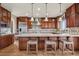 Gourmet kitchen featuring custom cabinetry, granite countertops, stainless steel appliances, and a large center island at 5192 Sedona Dr, Parker, CO 80134