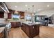 Open kitchen featuring stainless steel appliances, granite counters, custom cabinets, and an island at 5192 Sedona Dr, Parker, CO 80134