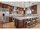Gourmet kitchen with stainless steel appliances, granite counters, custom cabinets, and an island with seating at 5192 Sedona Dr, Parker, CO 80134