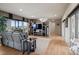 Relaxing living room with hardwood floors, plush seating, and a media center with built-in shelves and large windows at 5192 Sedona Dr, Parker, CO 80134