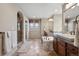 This main bathroom features dual sinks, a soaking tub, walk-in shower, and tile flooring at 5192 Sedona Dr, Parker, CO 80134