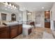 The main bathroom features dual sinks, a soaking tub, tile flooring, and dark wood cabinetry at 5192 Sedona Dr, Parker, CO 80134