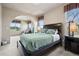 Main bedroom featuring comfortable furniture, large windows, and an arched entry to a sitting area at 5192 Sedona Dr, Parker, CO 80134