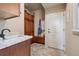 Mud room featuring cabinets, bench, sink and access to outside at 5192 Sedona Dr, Parker, CO 80134