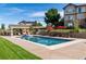 Stunning in-ground pool with a covered patio, outdoor seating, and lush landscaping, offering a relaxing retreat at 5192 Sedona Dr, Parker, CO 80134