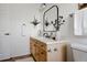 Bathroom featuring light wood vanity, black faucet, and sleek design at 4500 E Louisiana Ave, Denver, CO 80246