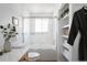 Bathroom featuring tiled shower/tub, white shelving, and plant decor at 4500 E Louisiana Ave, Denver, CO 80246