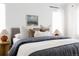 Bedroom view highlights inviting pillows, neutral colors, and wall art at 4500 E Louisiana Ave, Denver, CO 80246