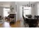 Elegant dining room featuring a fireplace, hardwood floors, and lots of natural light at 4500 E Louisiana Ave, Denver, CO 80246