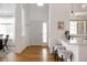 Bright entryway with light hardwood floors, modern fixtures, and seamless access to the kitchen at 4500 E Louisiana Ave, Denver, CO 80246