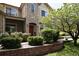 Charming two-story home showcasing a stone facade, arched entryway, well-maintained landscaping, and a welcoming front entrance at 4500 E Louisiana Ave, Denver, CO 80246