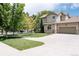 Beautiful home with a spacious driveway, attached garage, and well-maintained lawn at 4500 E Louisiana Ave, Denver, CO 80246