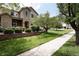 Charming two-story home featuring stone accents, a well-manicured lawn, and mature trees at 4500 E Louisiana Ave, Denver, CO 80246