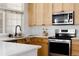 Well-equipped kitchen showcasing stainless steel appliances, light cabinets, and a sleek black faucet at 4500 E Louisiana Ave, Denver, CO 80246