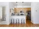 Modern kitchen with stainless steel appliances, light wood cabinets, a breakfast bar with seating, and hardwood floors at 4500 E Louisiana Ave, Denver, CO 80246