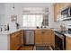 Modern kitchen with stainless steel appliances, light wood cabinets, and bright natural light at 4500 E Louisiana Ave, Denver, CO 80246