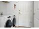 Clean laundry room with white washer and dryer units at 4500 E Louisiana Ave, Denver, CO 80246
