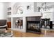 Inviting living room with a fireplace, built-in shelves, and an open layout, perfect for entertaining and relaxation at 4500 E Louisiana Ave, Denver, CO 80246