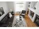 Bright living room with modern decor, fireplace, neutral tones, and large windows, offering an open and inviting space at 4500 E Louisiana Ave, Denver, CO 80246