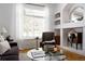 Bright living room with a comfortable sofa, accent chair, large windows, and stylish decor, creating a cozy atmosphere at 4500 E Louisiana Ave, Denver, CO 80246