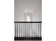 Bright stairwell with black banister offering a view to the entryway and modern lighting fixture at 4500 E Louisiana Ave, Denver, CO 80246