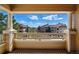 Balcony view overlooking well-maintained buildings and distant scenery on a bright, sunny day at 9557 W San Juan Cir # 306, Littleton, CO 80128