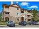 Inviting three-story condo building showcases a stone facade, private balconies, and ample parking spaces at 9557 W San Juan Cir # 306, Littleton, CO 80128