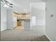 Open kitchen showcasing bright wood cabinetry and modern white appliances leading into the living area at 9557 W San Juan Cir # 306, Littleton, CO 80128