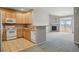 Open concept: Cozy kitchen with tiled floors next to a carpeted living area featuring a fireplace at 9557 W San Juan Cir # 306, Littleton, CO 80128