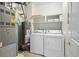 A functional laundry room equipped with a washer, dryer, and utility sink at 9557 W San Juan Cir # 306, Littleton, CO 80128