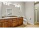 Bright bathroom featuring double sinks, granite countertops and tile flooring at 1057 W Century Dr # 112, Louisville, CO 80027