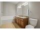 Large bathroom featuring a soaking tub, wooden cabinets, and a granite countertop at 1057 W Century Dr # 112, Louisville, CO 80027