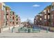 View of condo buildings from street level with well kept common area including benches and manicured landscaping at 1057 W Century Dr # 112, Louisville, CO 80027