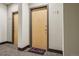 Condo front door with light wood finish, unit number 112, and a cute welcome home mat at 1057 W Century Dr # 112, Louisville, CO 80027