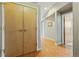 Hallway featuring wooden floors, closets, and access to different rooms at 1057 W Century Dr # 112, Louisville, CO 80027