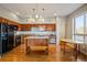 Bright kitchen featuring wood cabinets, granite counters, stainless steel appliances and a center island at 1057 W Century Dr # 112, Louisville, CO 80027
