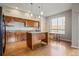Bright kitchen featuring wood cabinets, granite counters, stainless steel appliances and a center island at 1057 W Century Dr # 112, Louisville, CO 80027