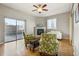 Cozy living room featuring a fireplace, large windows, and stylish green patterned arm chairs at 1057 W Century Dr # 112, Louisville, CO 80027