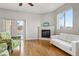 Bright living room featuring a fireplace, sliding glass doors, and a comfortable white couch at 1057 W Century Dr # 112, Louisville, CO 80027