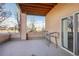 Outdoor patio with covered wood ceiling and view of trees and the neighborhood at 1057 W Century Dr # 112, Louisville, CO 80027