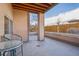 Outdoor patio with covered wood ceiling and view of trees and the neighborhood at 1057 W Century Dr # 112, Louisville, CO 80027