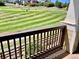 Back porch overlooking the golf course with wooden railing and porch flooring at 1368 Royal Troon Dr, Castle Rock, CO 80104