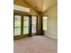 Cozy bedroom with high ceilings and natural light from the sliding glass doors at 1368 Royal Troon Dr, Castle Rock, CO 80104
