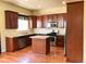 Open kitchen features granite countertops, stainless appliances, and a central island at 1368 Royal Troon Dr, Castle Rock, CO 80104
