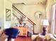 Inviting living room showcasing staircase, decorative mirror, and comfortable seating arrangement at 1368 Royal Troon Dr, Castle Rock, CO 80104