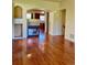 Open-concept living room with hardwood floors and an archway to the kitchen at 1368 Royal Troon Dr, Castle Rock, CO 80104